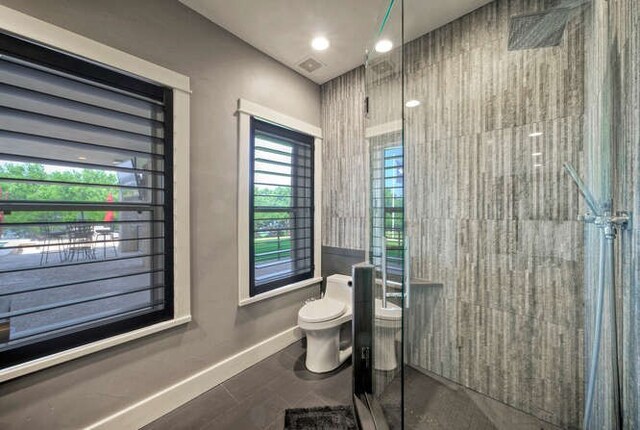 15210 Rainbow One St, Austin, TX 78734 - bathroom with toilet, tiled shower, and baseboards