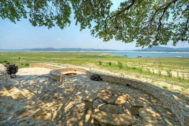 view of patio / terrace featuring a fire pit and a rural view