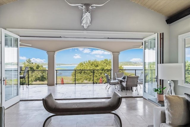 view of patio featuring a water view and a balcony