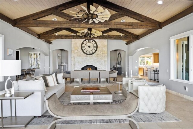 15210 Rainbow One St, Austin, TX 78734 - tiled living area featuring wood ceiling, healthy amount of natural light, a large fireplace, arched walkways, and baseboards