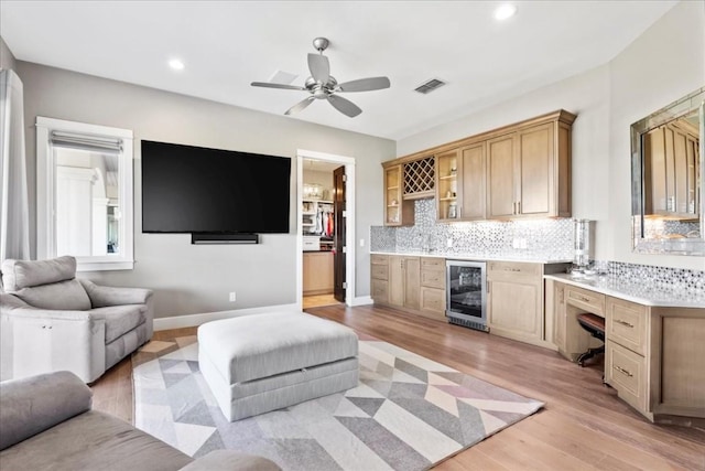 living room with wine cooler, recessed lighting, bar area, visible vents, and light wood-type flooring