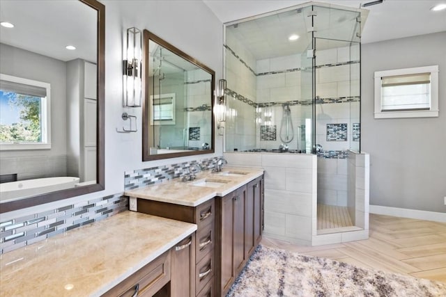 full bathroom featuring recessed lighting, backsplash, a stall shower, vanity, and baseboards