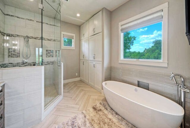 15210 Rainbow One St, Austin, TX 78734 - bathroom featuring a stall shower, healthy amount of natural light, a freestanding bath, recessed lighting, and vanity