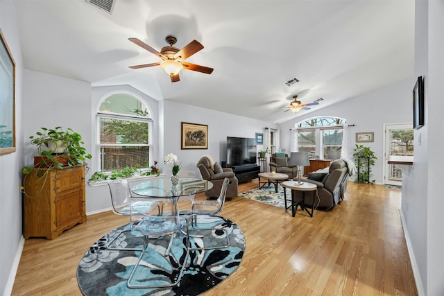 dining area featuring visible vents, vaulted ceiling, light wood finished floors, and ceiling fan