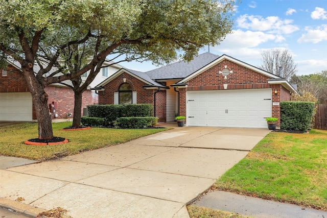 view of front facade with driveway, brick siding, a shingled roof, an attached garage, and a front yard