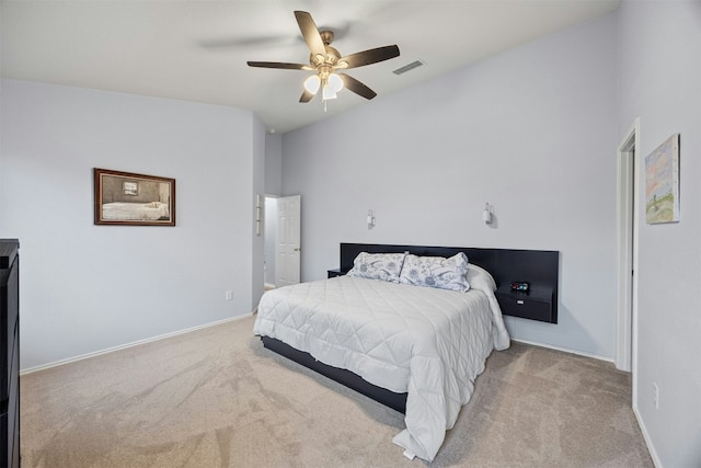 bedroom with baseboards, visible vents, and light colored carpet