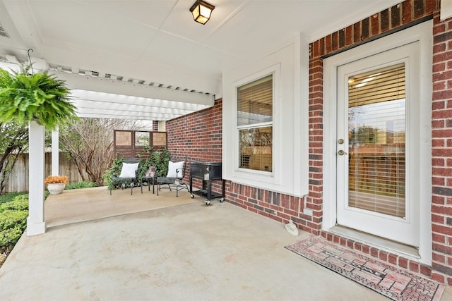 view of patio with a porch and fence