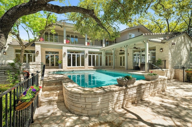 view of pool with a fenced in pool, french doors, a patio, ceiling fan, and fence