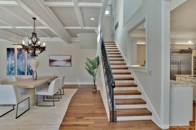 dining area with ornamental molding, coffered ceiling, visible vents, and light wood-style floors