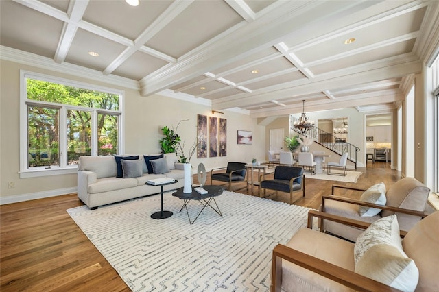 living area with stairway, a chandelier, coffered ceiling, and wood finished floors