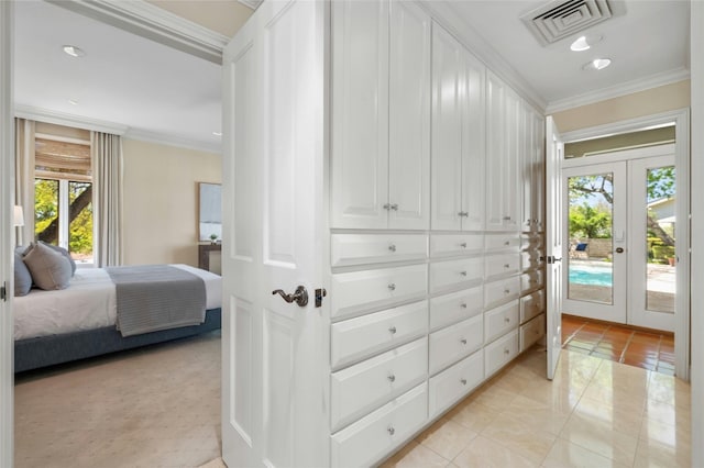 interior space featuring access to outside, visible vents, crown molding, and french doors