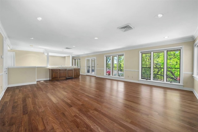 unfurnished living room with dark wood-style floors, crown molding, recessed lighting, visible vents, and baseboards