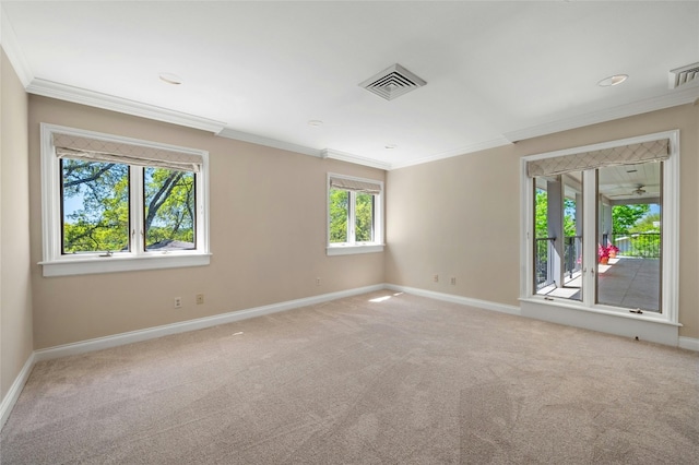 empty room featuring ornamental molding, carpet, visible vents, and baseboards