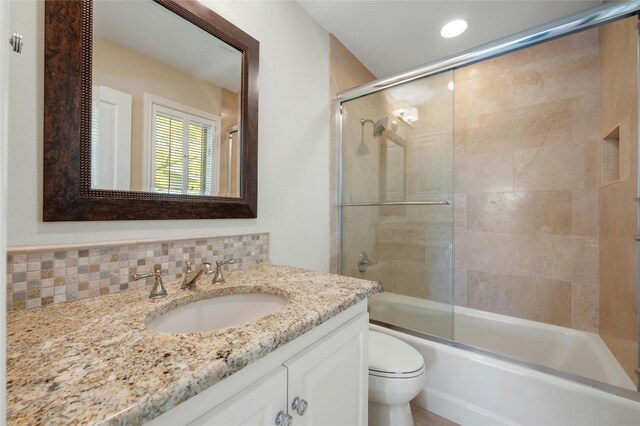126 Firebird St, Lakeway, TX 78734 - bathroom with toilet, vanity, bath / shower combo with glass door, and decorative backsplash