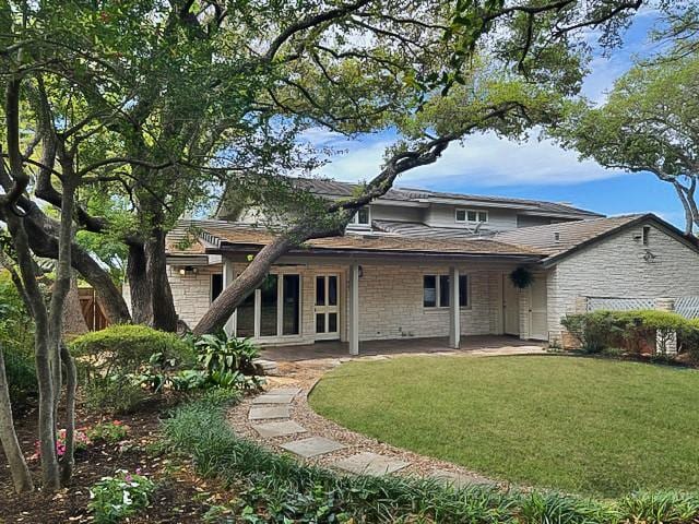 126 Firebird St, Lakeway, TX 78734 - rear view of house with a patio area, a lawn, and stone siding