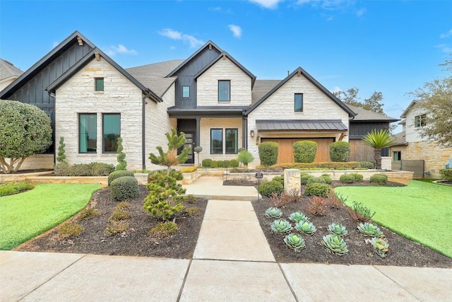 view of front of house featuring a standing seam roof, stone siding, a front lawn, and board and batten siding