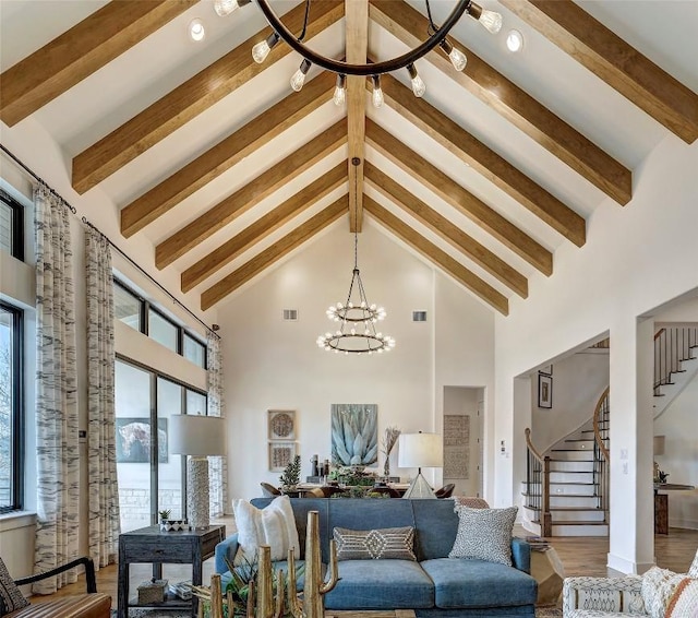 living room featuring an inviting chandelier, visible vents, stairs, and high vaulted ceiling