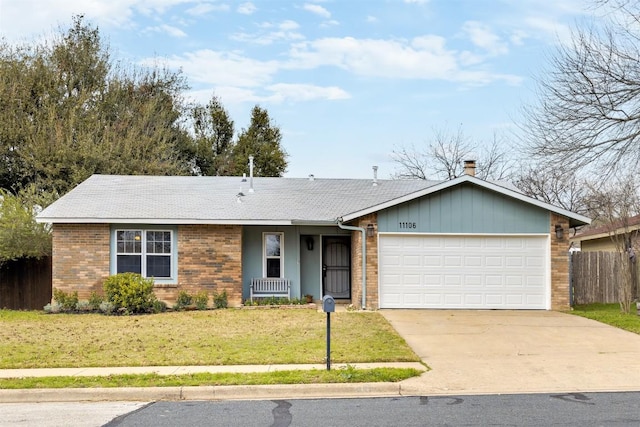 ranch-style home with brick siding, concrete driveway, an attached garage, fence, and a front yard