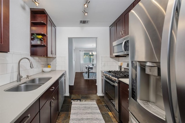 kitchen featuring stainless steel appliances, a sink, visible vents, light countertops, and open shelves