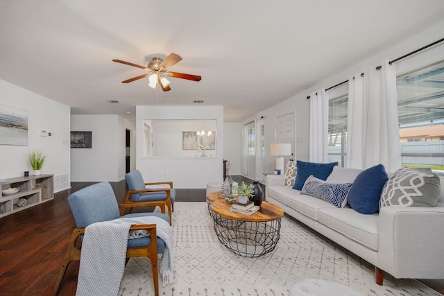 living room with wood finished floors and a ceiling fan