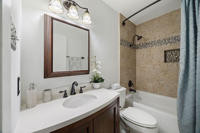 full bath with a textured wall, shower / tub combo, vanity, and toilet