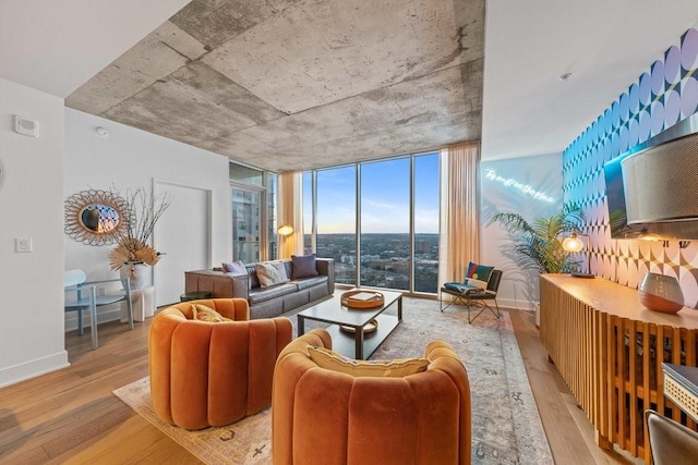 living room with light wood-type flooring, expansive windows, and baseboards