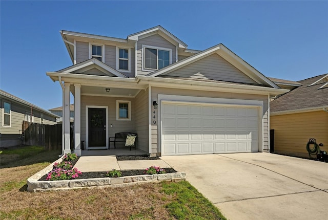 view of front of home featuring covered porch, concrete driveway, an attached garage, and fence