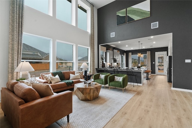 living room with visible vents and light wood-style floors