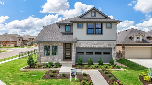 view of front of house featuring a shingled roof, a front yard, brick siding, and stucco siding