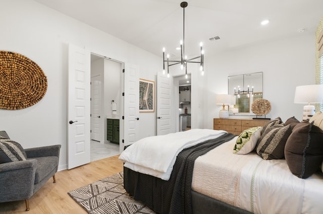 bedroom with visible vents, connected bathroom, light wood-type flooring, recessed lighting, and an inviting chandelier