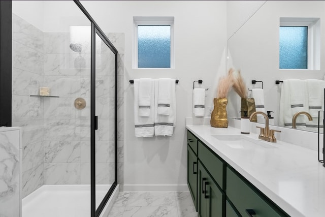 bathroom featuring vanity, baseboards, marble finish floor, and a stall shower