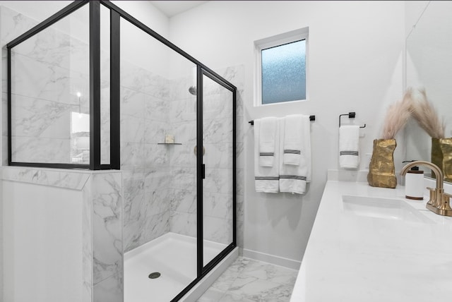 bathroom with baseboards, vanity, marble finish floor, and a shower stall