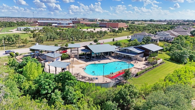2705 Sage Ranch Dr Unit 24, Leander, TX 78641 - drone / aerial view of a pool area and a tree filled landscape