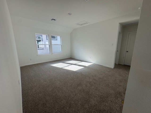 2705 Sage Ranch Dr Unit 24, Leander, TX 78641 - empty room with carpet and lofted ceiling