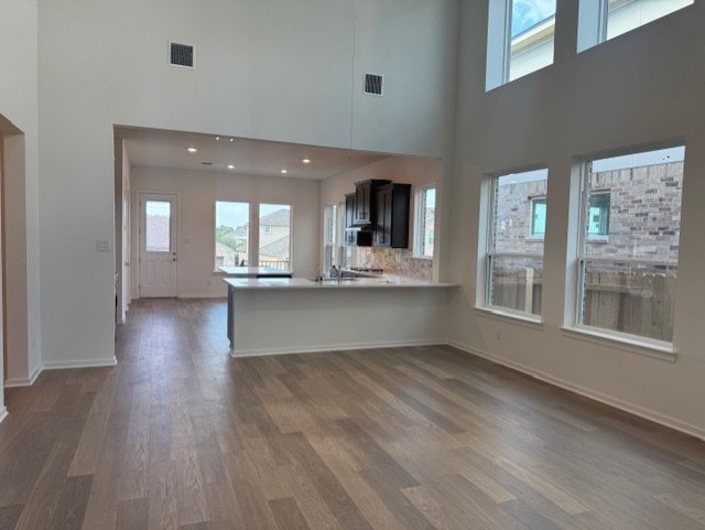2705 Sage Ranch Dr Unit 24, Leander, TX 78641 - unfurnished living room with dark wood-type flooring, a high ceiling, and plenty of natural light