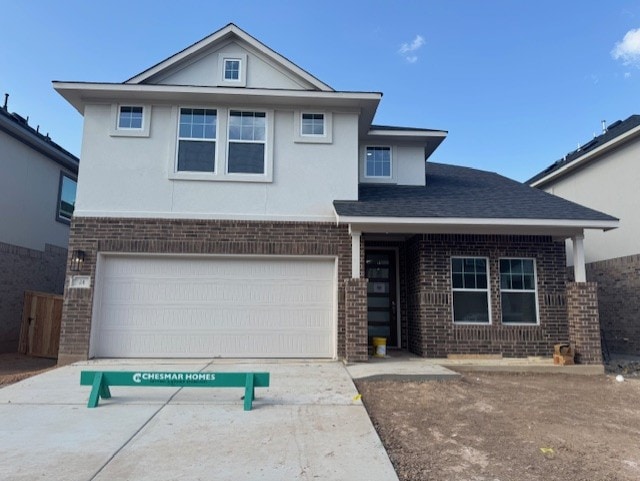 2705 Sage Ranch Dr Unit 24, Leander, TX 78641 - view of front of house with brick siding, a garage, and stucco siding