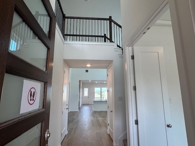 2705 Sage Ranch Dr Unit 24, Leander, TX 78641 - corridor featuring wood finished floors, stairs, and a towering ceiling
