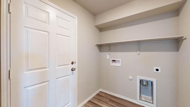 clothes washing area with hookup for a washing machine, hookup for a gas dryer, hookup for an electric dryer, wood finished floors, and laundry area