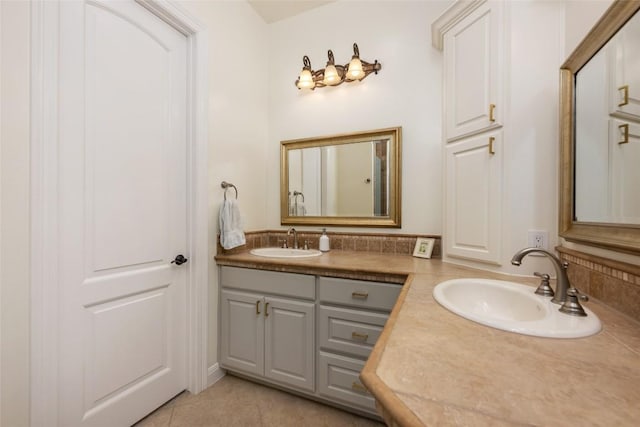 bathroom with double vanity, a sink, and tile patterned floors