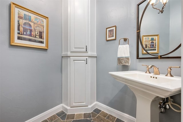 5807 City Park Rd Unit 14, Austin, TX 78730 - bathroom with baseboards and stone finish floors