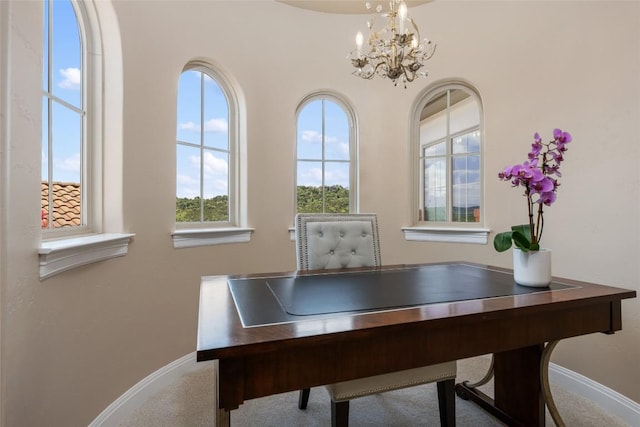 office space featuring a chandelier and baseboards