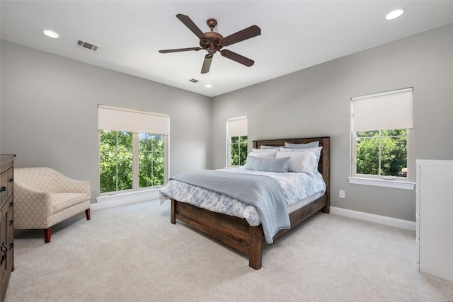 bedroom featuring light carpet, visible vents, and recessed lighting