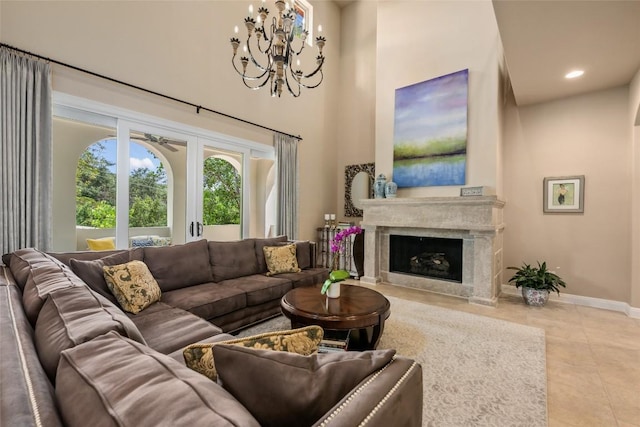 tiled living area featuring a fireplace, recessed lighting, a high ceiling, an inviting chandelier, and baseboards