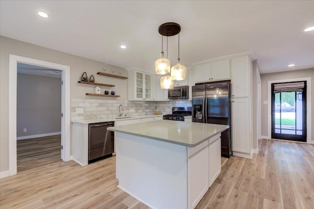 kitchen with white cabinets, glass insert cabinets, stainless steel appliances, light countertops, and open shelves