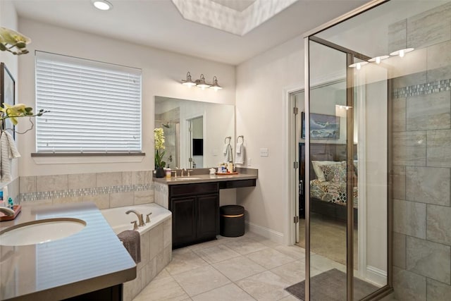 full bath with a garden tub, a sink, two vanities, a shower stall, and ensuite bath