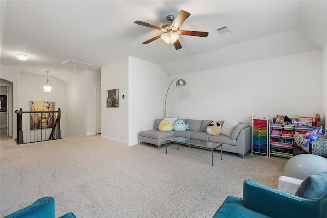 living area featuring lofted ceiling, visible vents, ceiling fan, and carpet