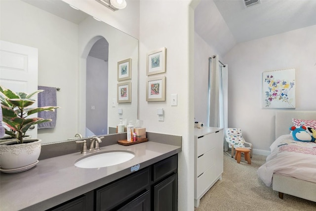 bathroom featuring visible vents, vanity, and ensuite bathroom