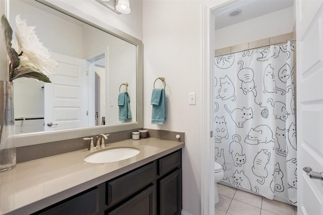 bathroom with toilet, a shower with curtain, vanity, and tile patterned floors