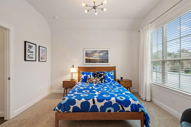 carpeted bedroom with lofted ceiling, baseboards, and a chandelier