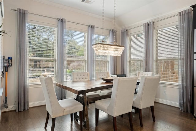 dining room featuring dark wood-style floors, baseboards, and ornamental molding